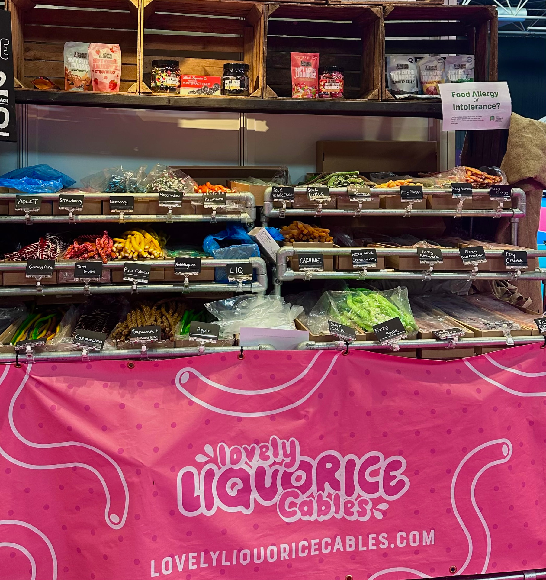 Lovely Liquorice Cables stand at the Summer Good Food Show 2026 at NEC Birmingham, packed with colourful sweets and a pink branded banner.