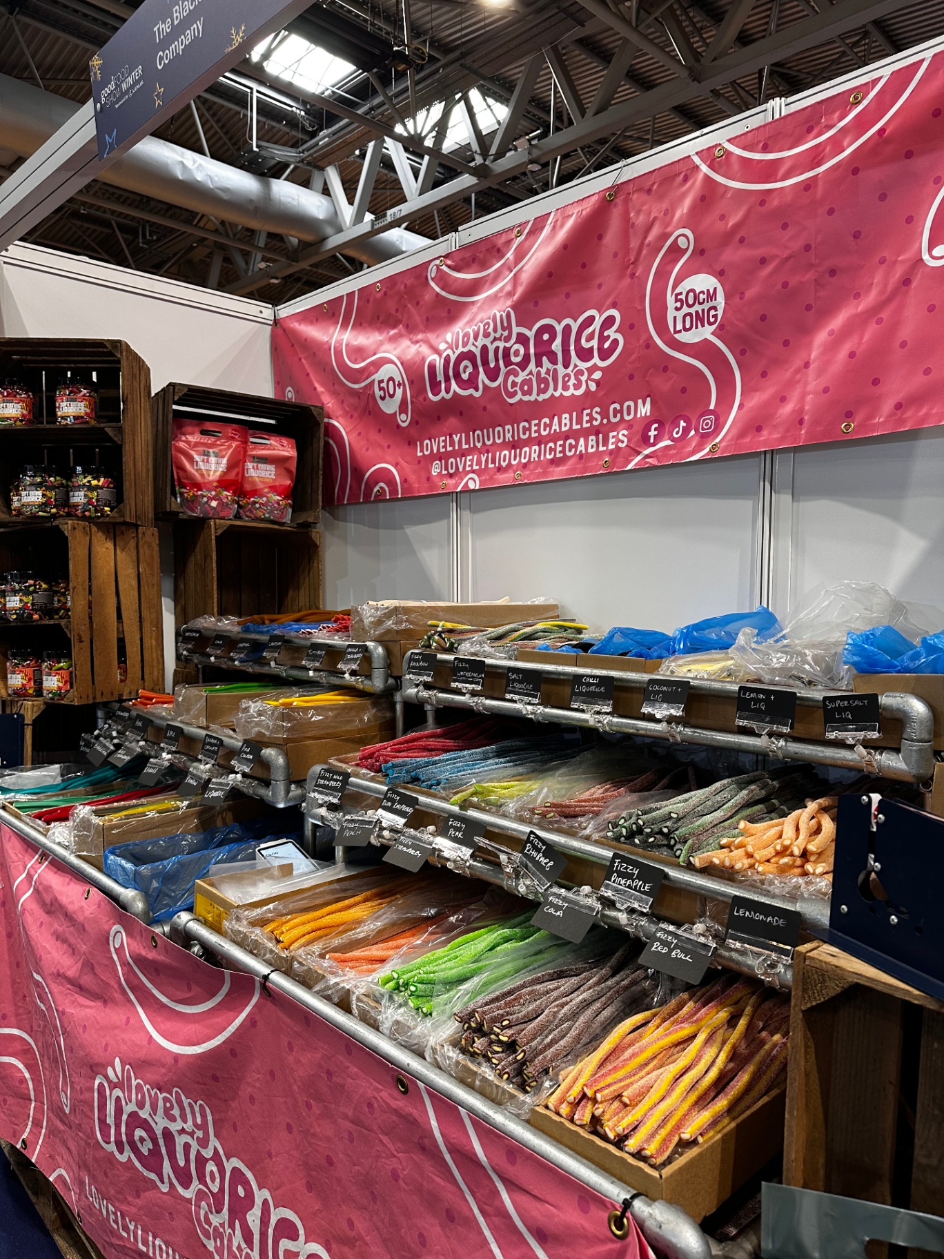 Lovely Liquorice Cables stand at the Winter Good Food Show 2025, with rows of colourful liquorice cables on display.